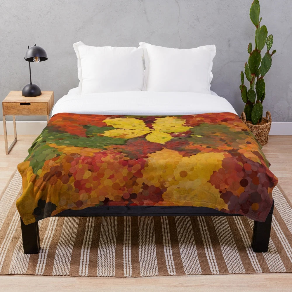 Autumn leaves-inspired plush blanket with warm, natural colors