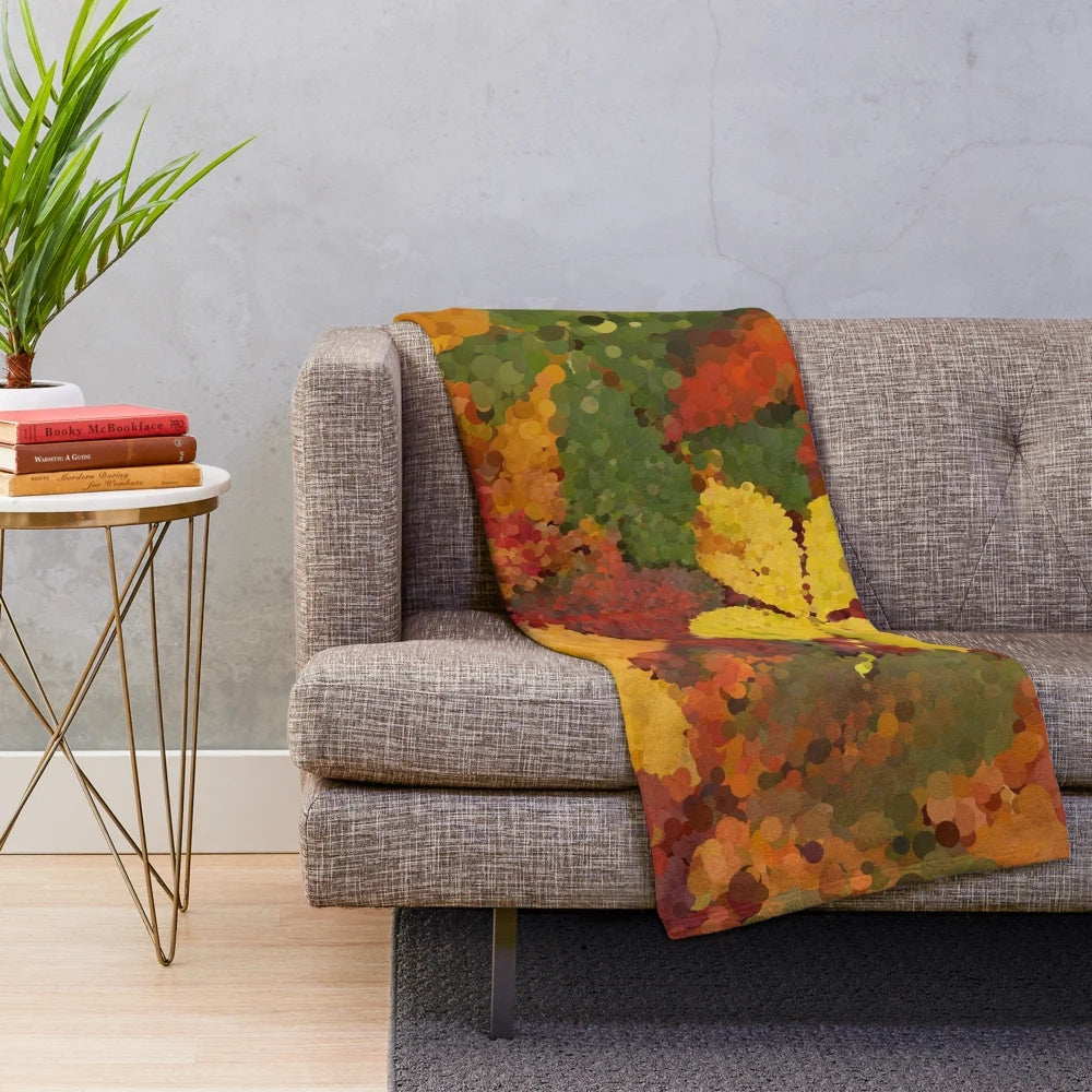 Autumn leaves-inspired plush blanket with warm, natural colors