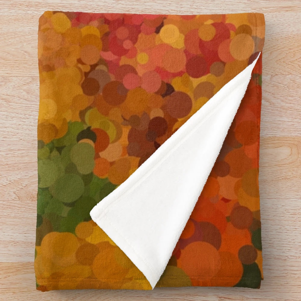 Autumn leaves-inspired plush blanket with warm, natural colors