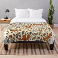 Soft and cozy plush blanket with a squirrel pattern, perfect for autumn and fall decor.