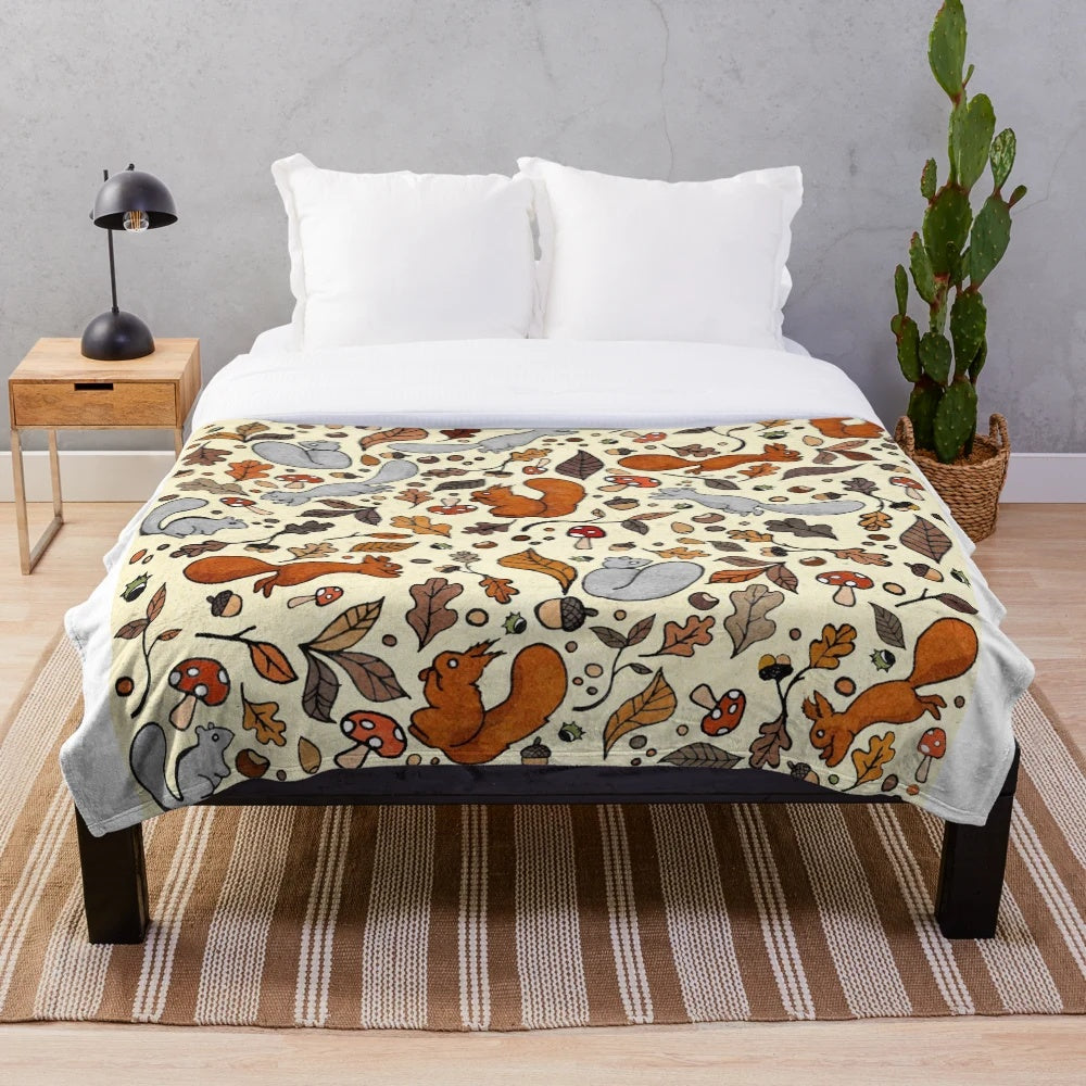 Soft and cozy plush blanket with a squirrel pattern, perfect for autumn and fall decor.