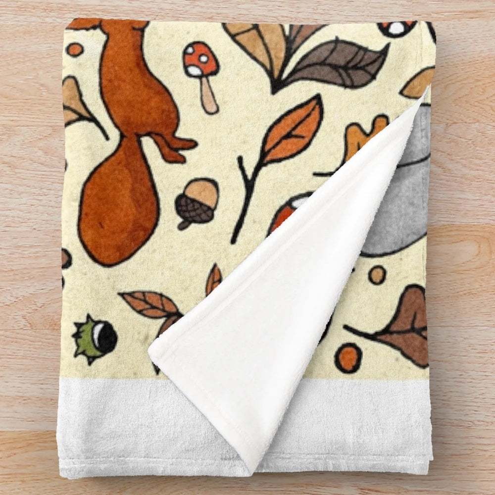 Soft and cozy plush blanket with a squirrel pattern, perfect for autumn and fall decor.