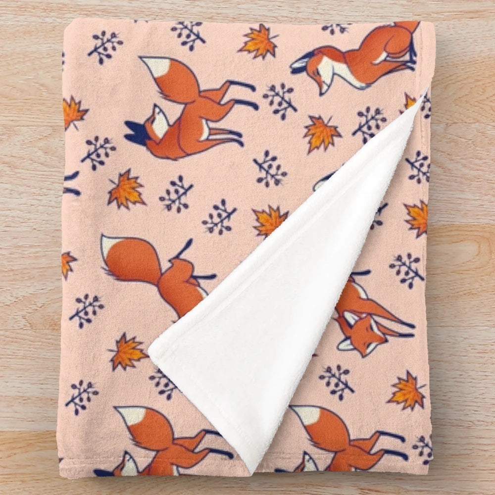 Red foxes print on a cozy, plush blanket