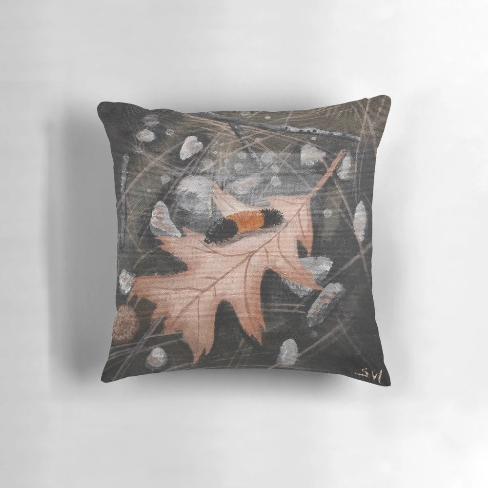 Woolly bear caterpillar sitting on fallen autumn leaves, a cozy home décor accent for fall.