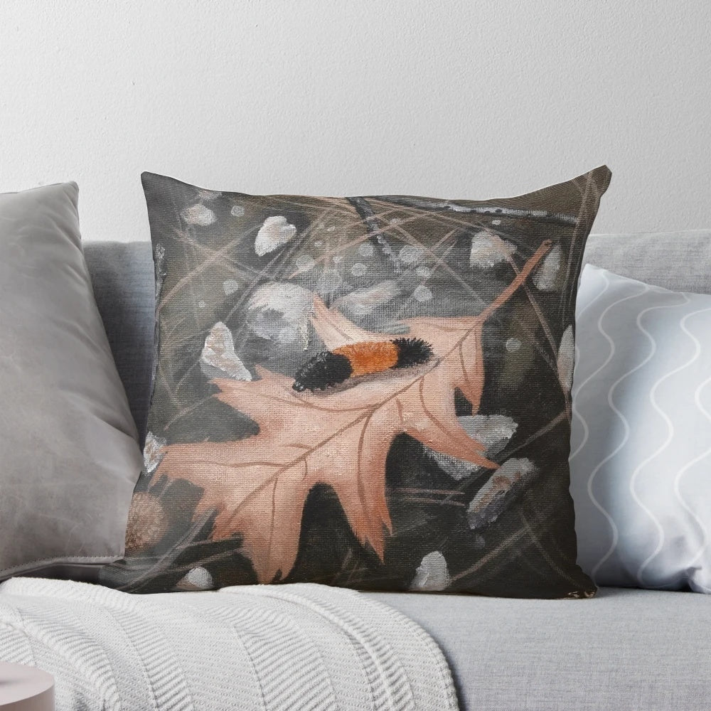 Woolly bear caterpillar sitting on fallen autumn leaves, a cozy home décor accent for fall.