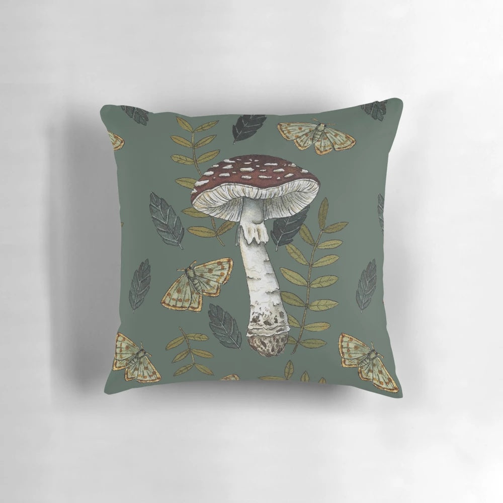 Decorative pillow featuring a botanical illustration of the Amanita muscaria mushroom surrounded by autumn leaves.