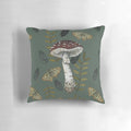 Decorative pillow featuring a botanical illustration of the Amanita muscaria mushroom surrounded by autumn leaves.