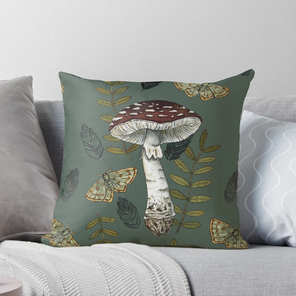 Decorative pillow featuring a botanical illustration of the Amanita muscaria mushroom surrounded by autumn leaves.