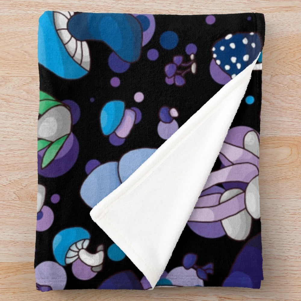 Cozy and plush mushroom-themed blanket in blue, lilac, and violet tones