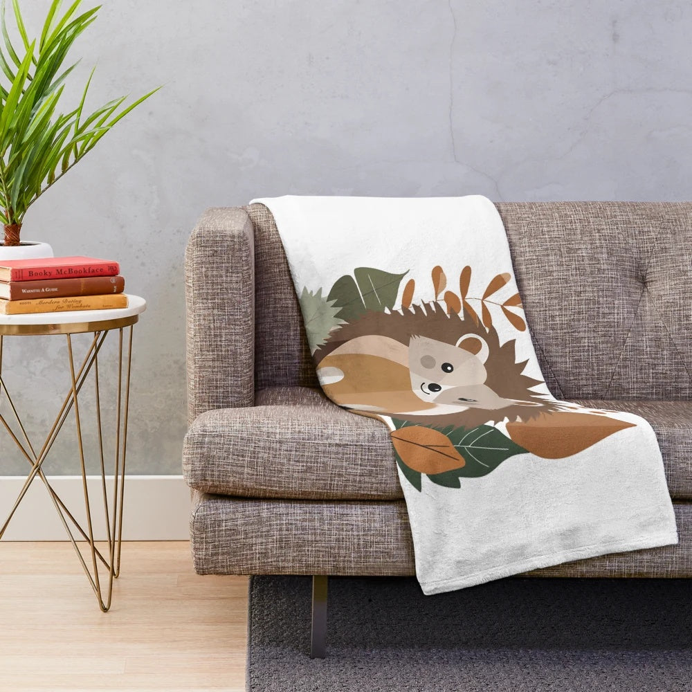 Plush blanket featuring a cozy autumn-themed hedgehog and forest animal design