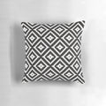 Aztec inspired black and white patterned throw pillow