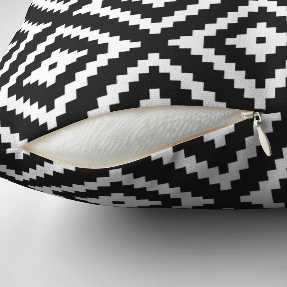 Aztec inspired black and white patterned throw pillow