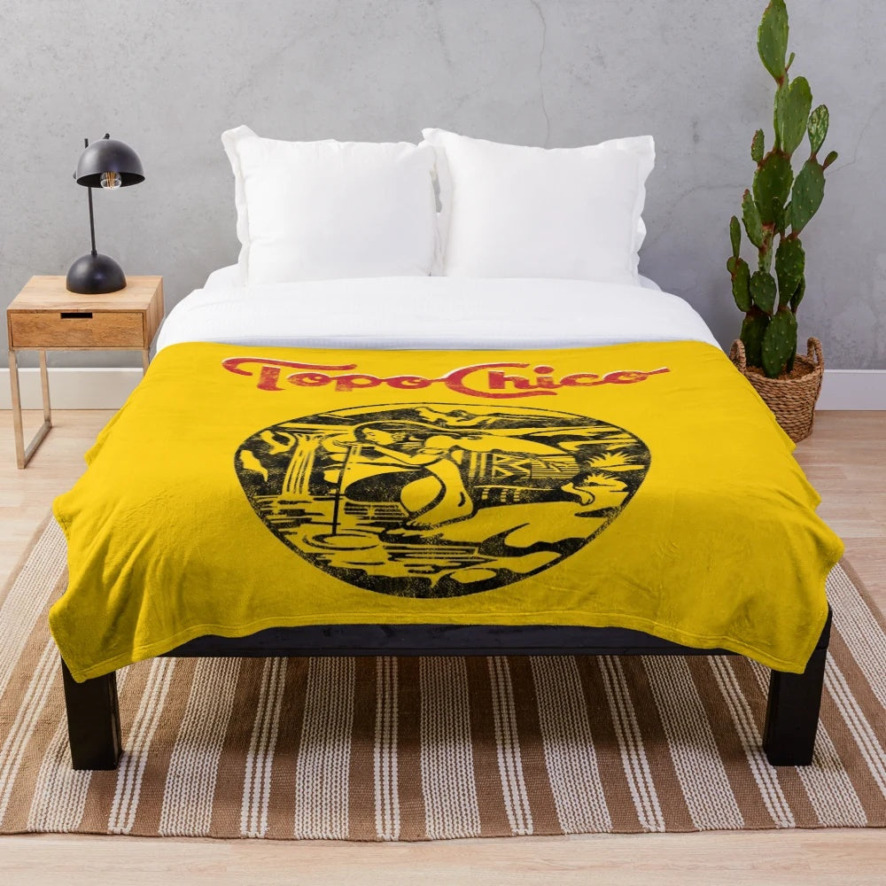 Aztec princess-inspired plush blanket featuring the worn and washed Topo Chico mineral water logo
