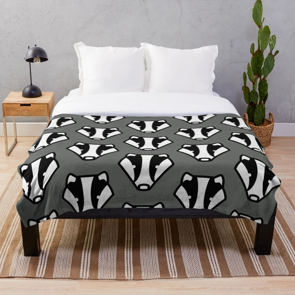 A plush, grey and black badger-inspired blanket