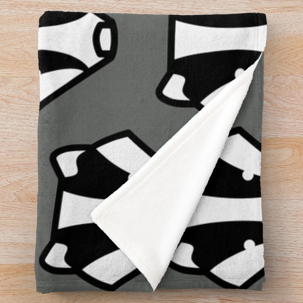 A plush, grey and black badger-inspired blanket