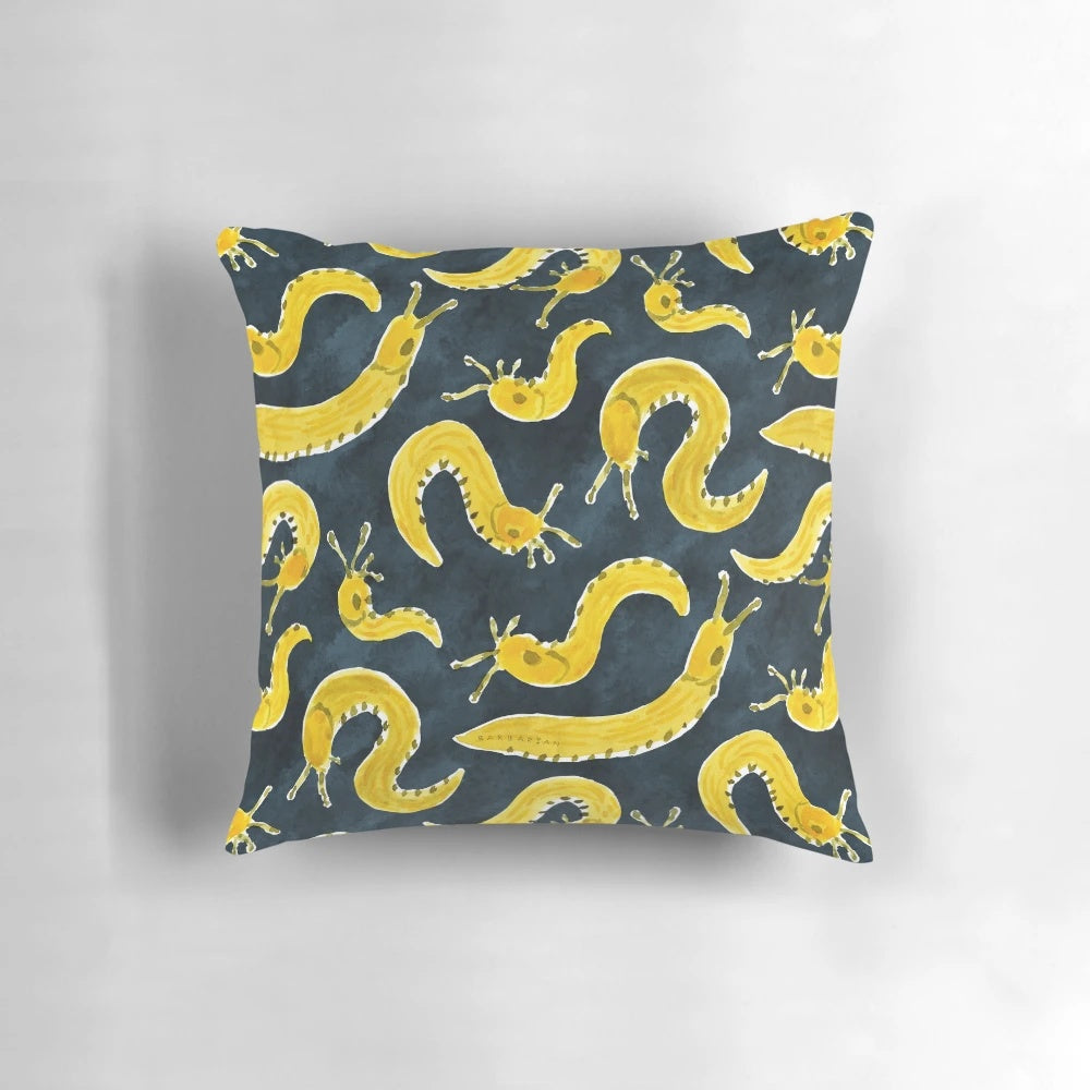 Vibrant yellow banana slug print on a cozy throw pillow for a playful, Pacific Northwest-inspired home accent.