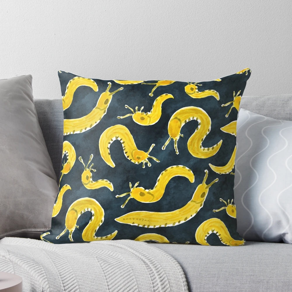 Vibrant yellow banana slug print on a cozy throw pillow for a playful, Pacific Northwest-inspired home accent.
