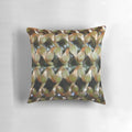 Closeup of a banksia bud on a decorative throw pillow, featuring a botanical pattern in green and orange.