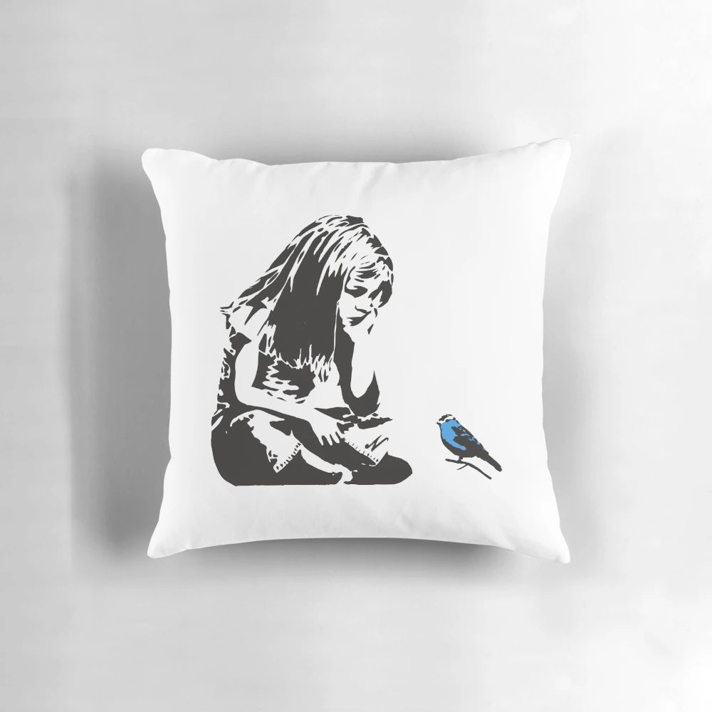 Pillow featuring a Banksy graffiti artwork of a girl with a blue bird