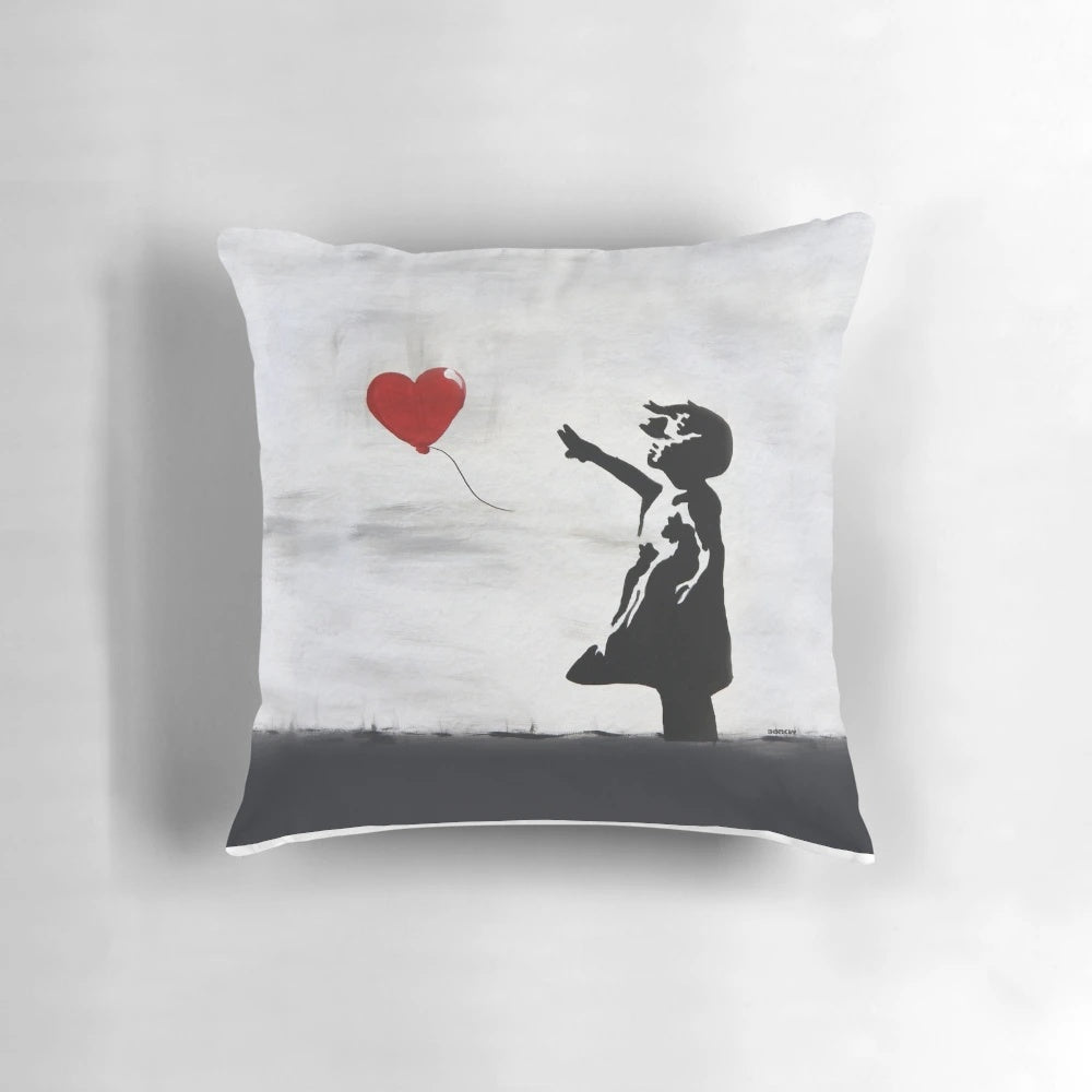 Banksy graffiti artwork featuring a girl with a heart-shaped balloon, printed on a high-quality pillow