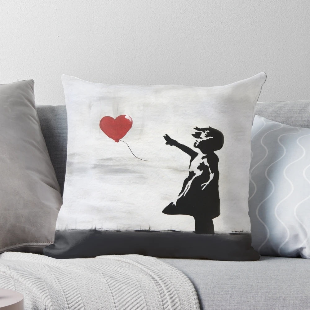 Banksy graffiti artwork featuring a girl with a heart-shaped balloon, printed on a high-quality pillow