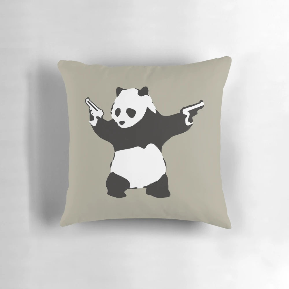Decorative pillow featuring Banksy's iconic panda graffiti holding guns