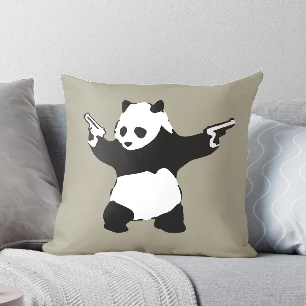 Decorative pillow featuring Banksy's iconic panda graffiti holding guns