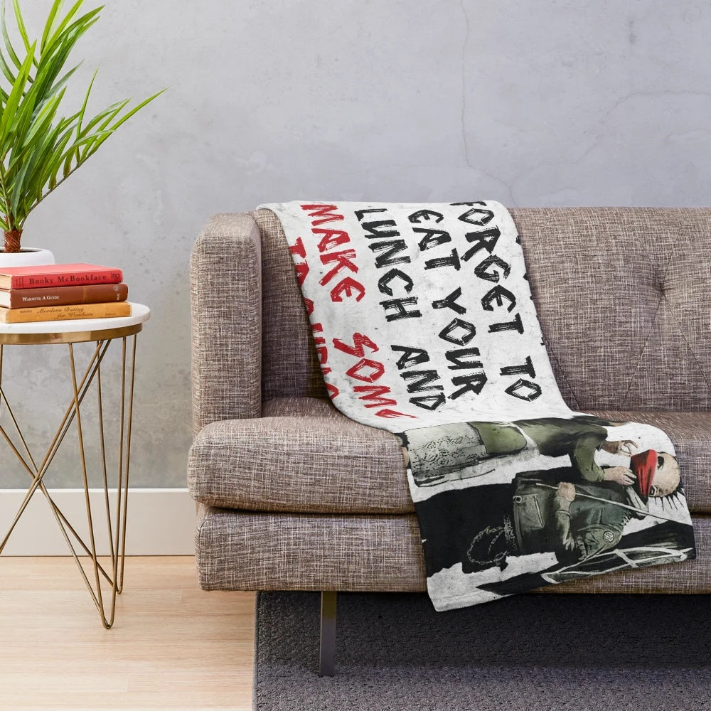 Banksy-inspired plush blanket with anti-capitalist graffiti-style art