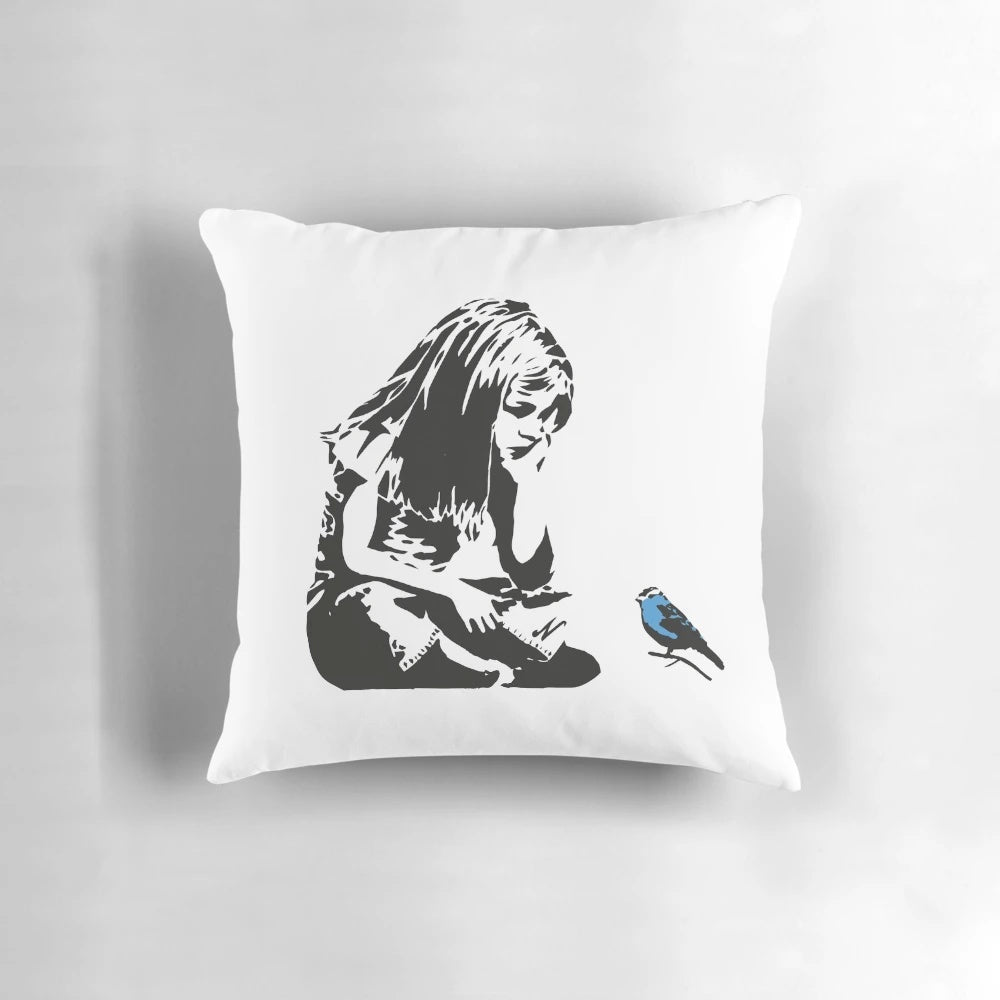 Pillow featuring a Banksy-style stencil graffiti of a girl with a blue bird, captured in Hull city centre, England.