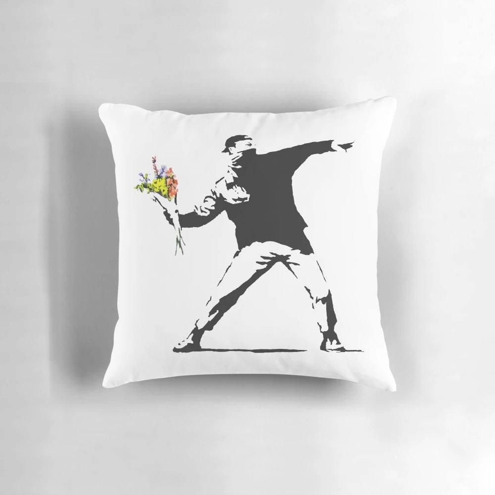 Pillow featuring Banksy's iconic "Flower Thrower" graffiti design, a symbol of nonviolent resistance.