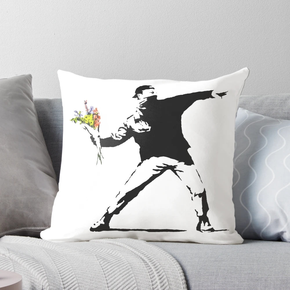 Pillow featuring Banksy's iconic "Flower Thrower" graffiti design, a symbol of nonviolent resistance.