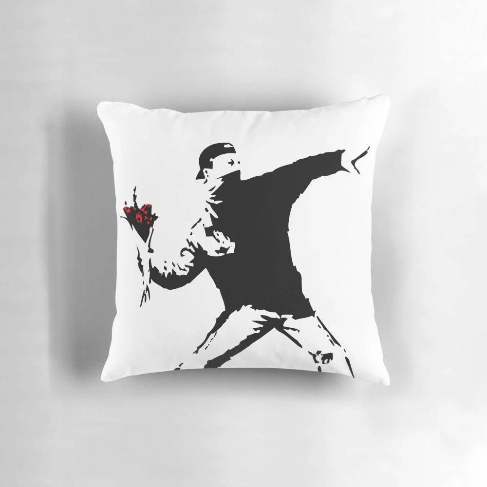 Vibrant pillow featuring the iconic Banksy "Flower Thrower" street art design