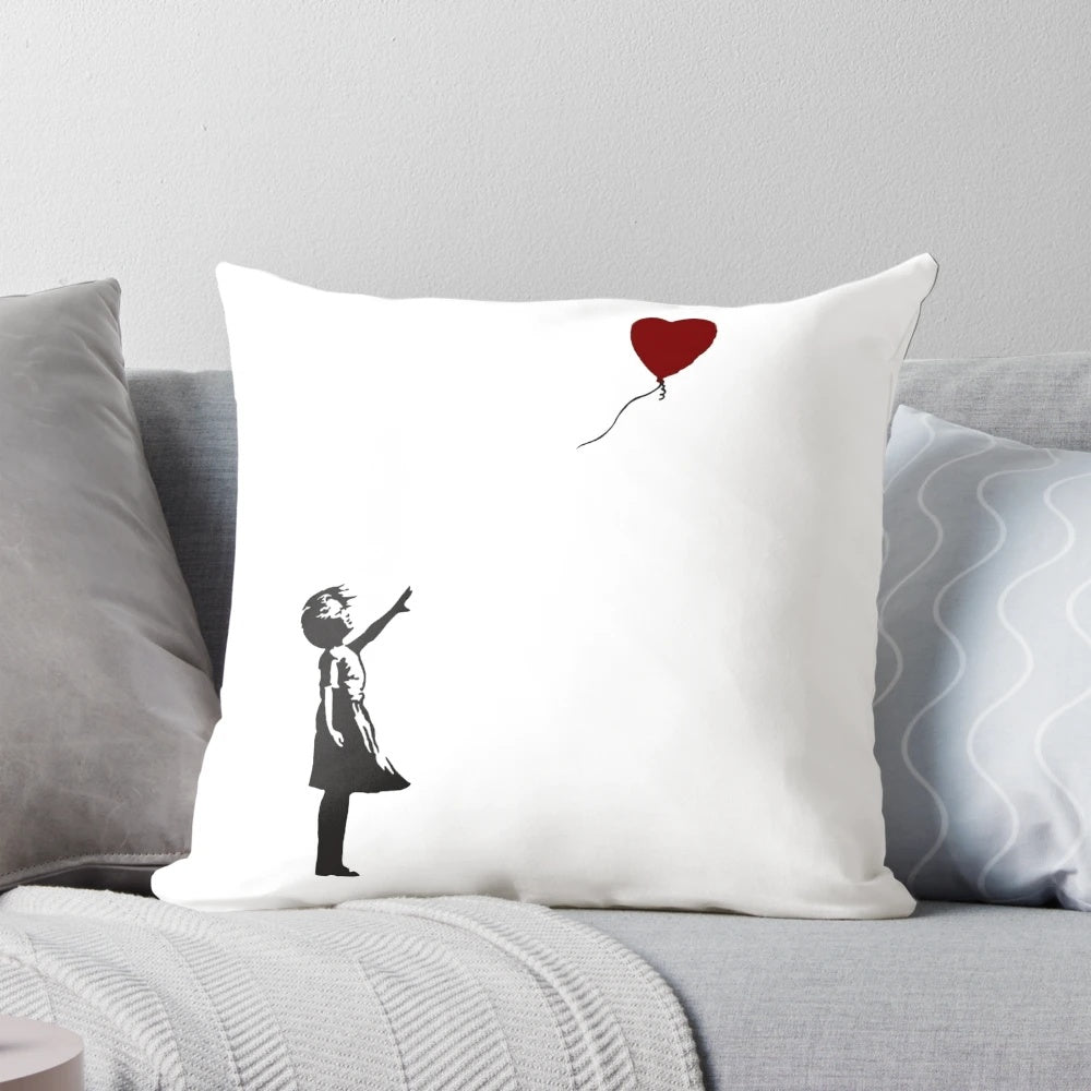 Decorative pillow featuring Banksy's iconic "Girl with Heart Balloon" artwork