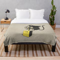 Banksy-inspired plush blanket featuring a monkey detonator design