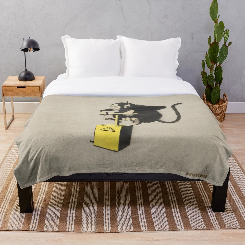 Banksy-inspired plush blanket featuring a monkey detonator design