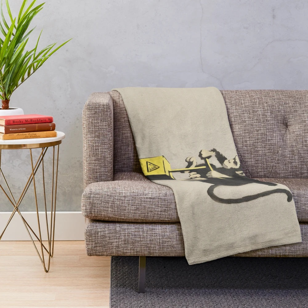 Banksy-inspired plush blanket featuring a monkey detonator design