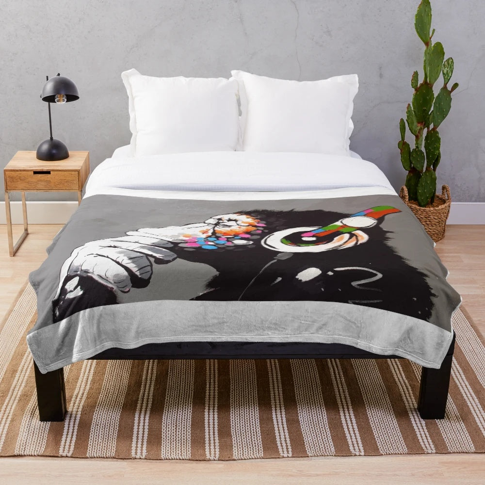 Banksy-inspired plush blanket featuring a monkey DJ with headphones