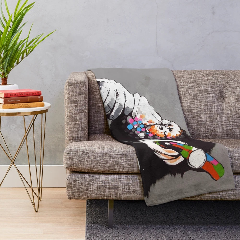 Banksy-inspired plush blanket featuring a monkey DJ with headphones