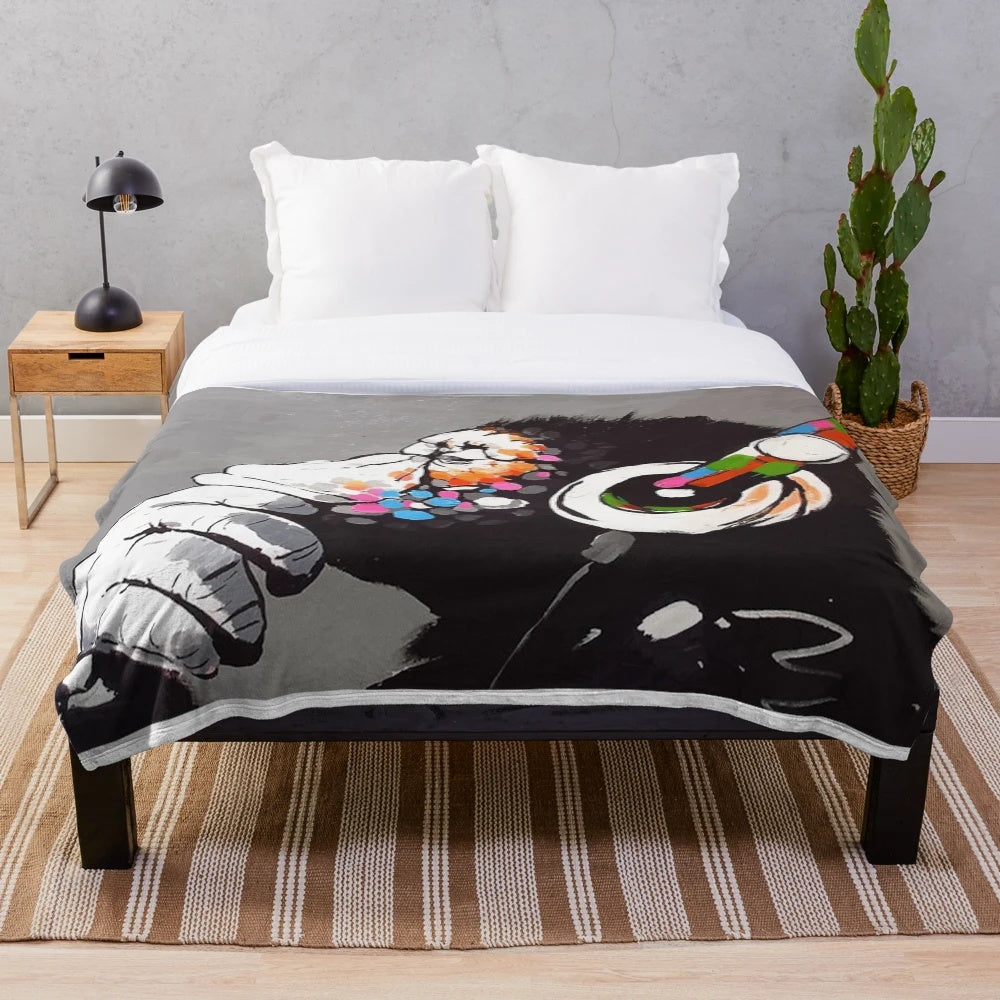 Plush blanket featuring a Banksy-style monkey DJ with headphones