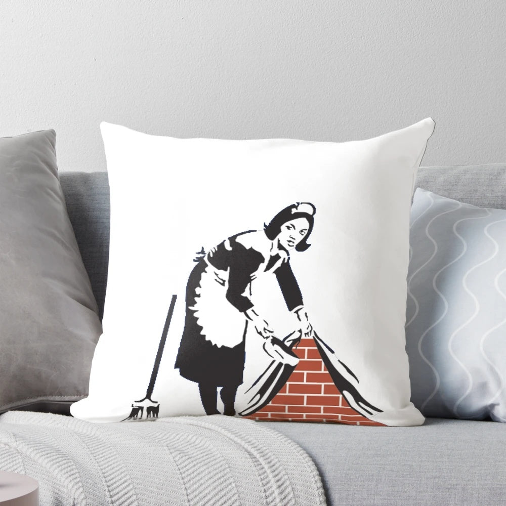 Banksy-inspired decorative pillow featuring the "Swept Under the Rug" artwork
