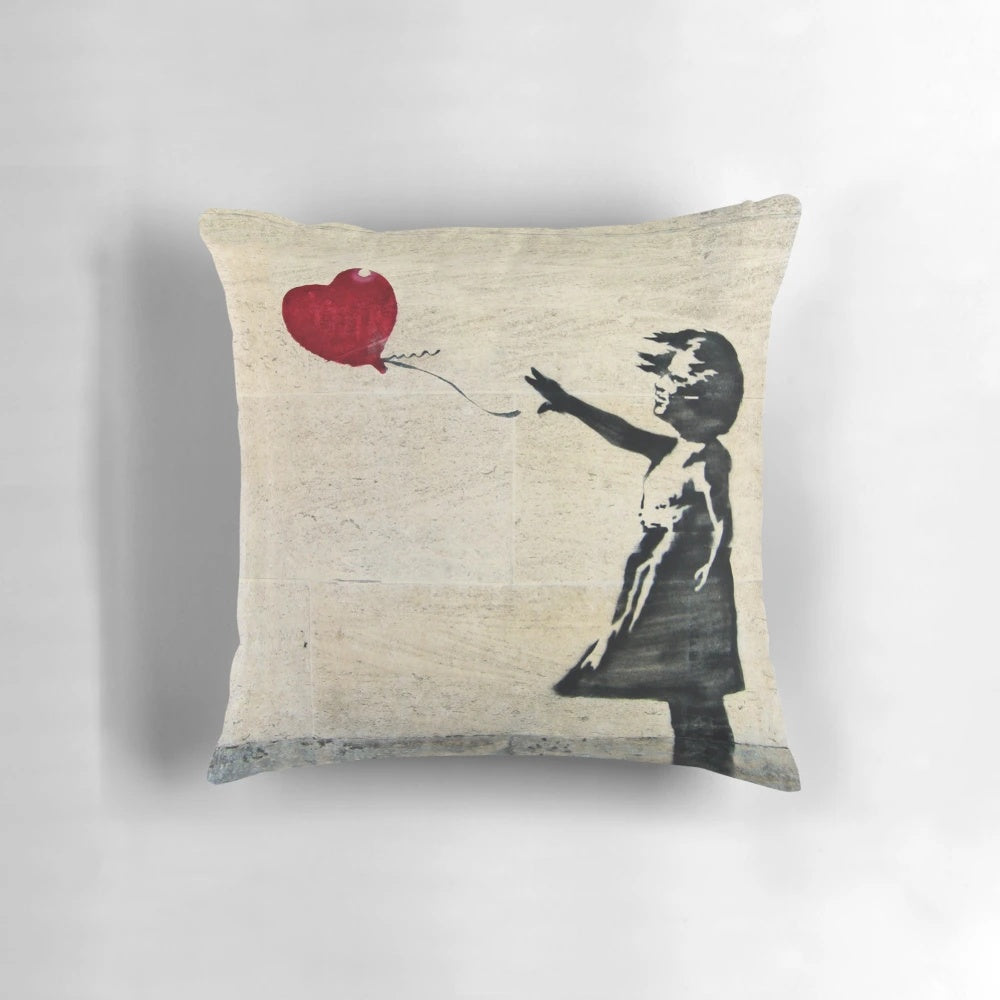 Decorative throw pillow featuring the iconic Banksy street art "Girl with a Red Balloon"