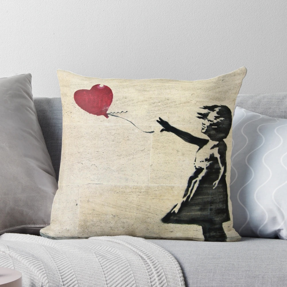 Decorative throw pillow featuring the iconic Banksy street art "Girl with a Red Balloon"