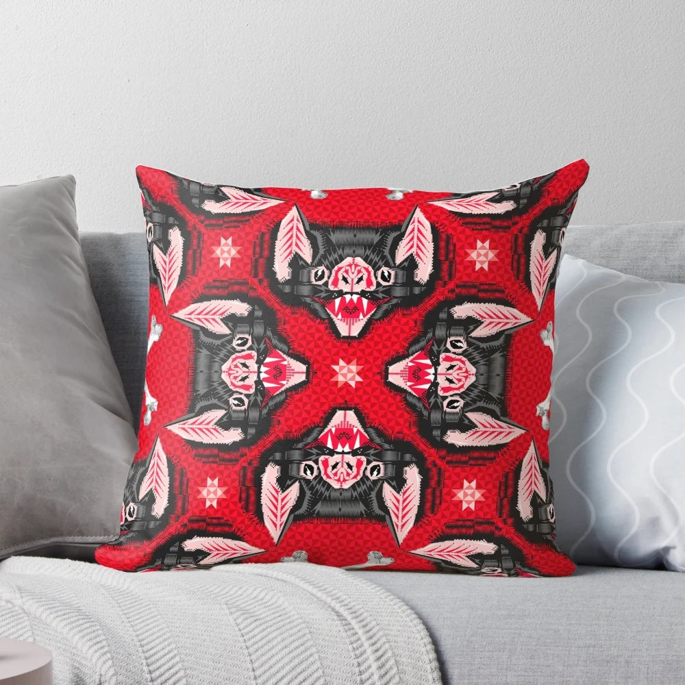 A throw pillow featuring a geometric bat head pattern in black and red, perfect for gothic and vampire-themed home decor.