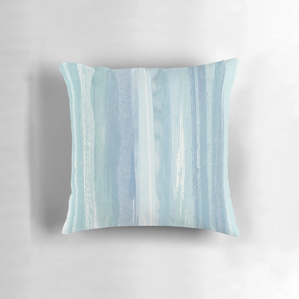 Beaching watercolor beach pillow with blue, turquoise, and white striped design