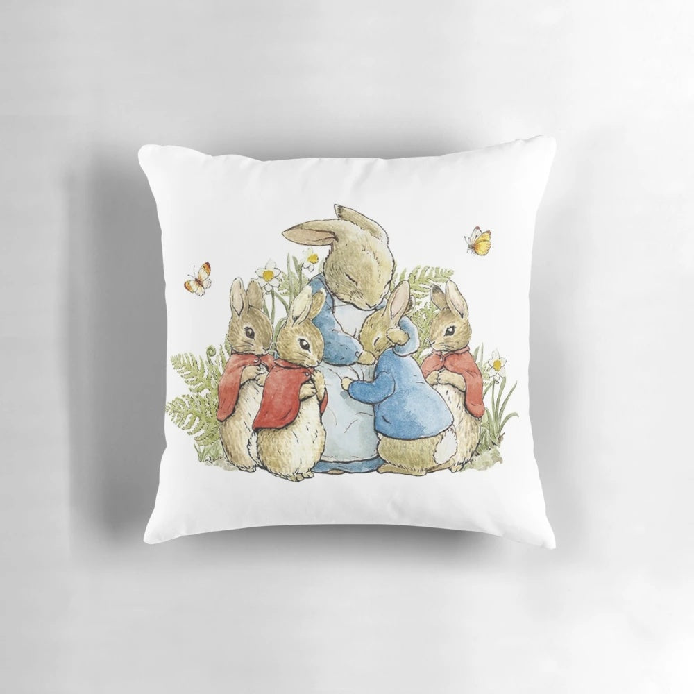 Soft, plush throw pillow featuring the iconic illustration of Peter Rabbit and his family from the classic children's book by Beatrix Potter.