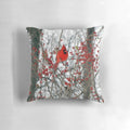 Vibrant red cardinal perched on a snowy branch, decorative holiday pillow
