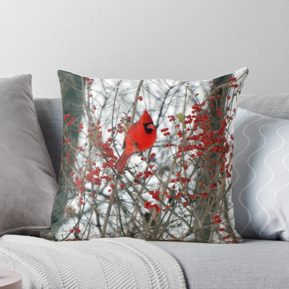 Vibrant red cardinal perched on a snowy branch, decorative holiday pillow