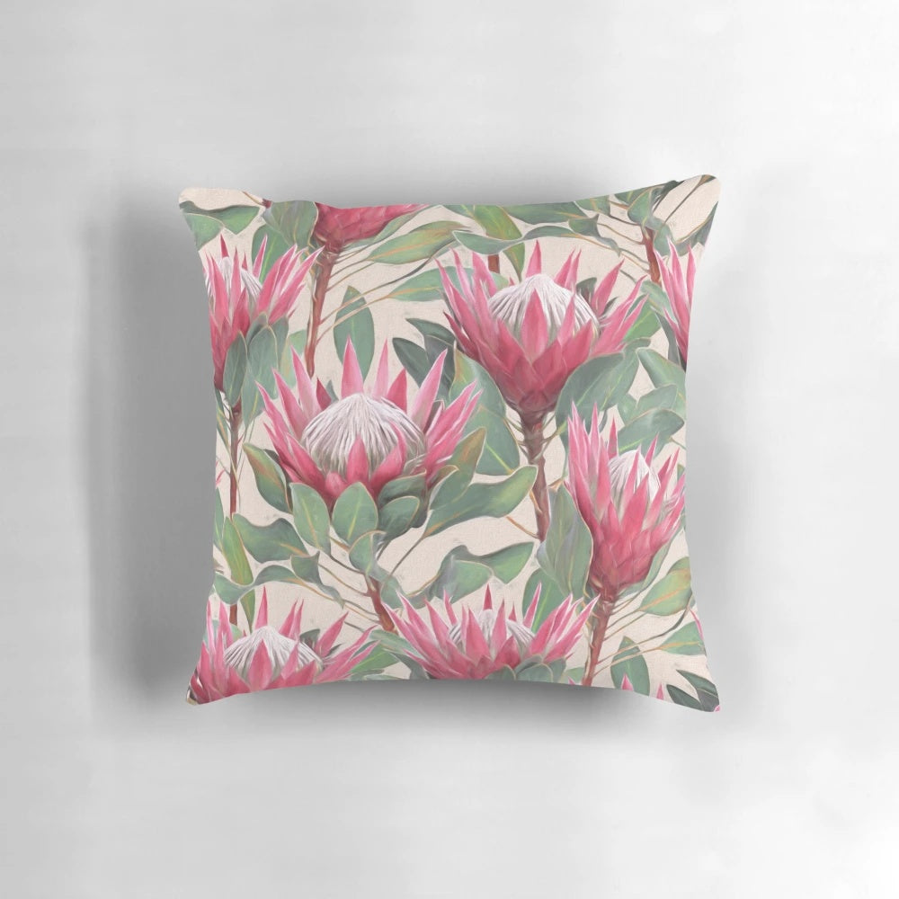 Cream-colored pillow with a painted design of vibrant king proteas and other botanical elements.