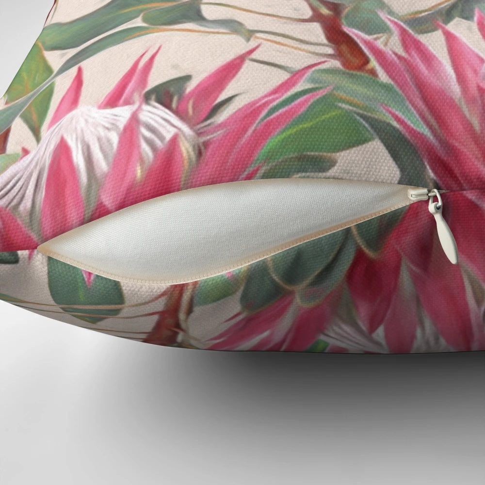 Cream-colored pillow with a painted design of vibrant king proteas and other botanical elements.