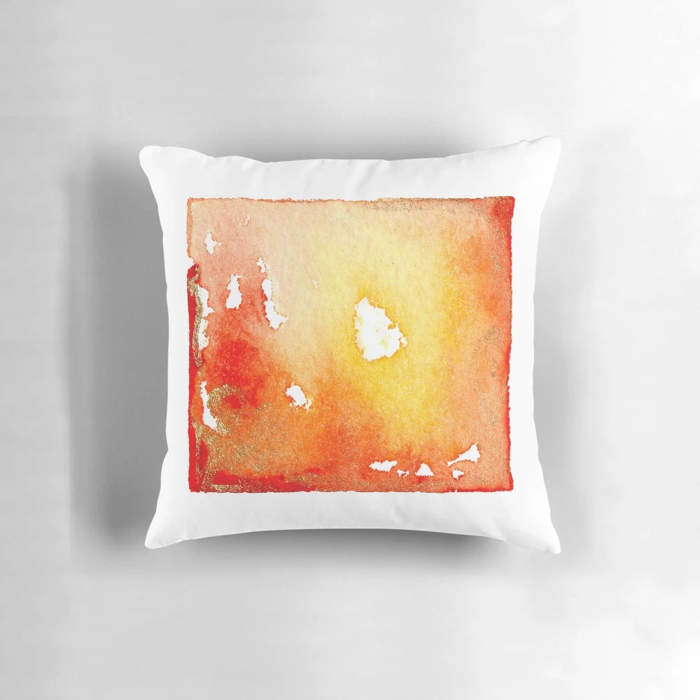 Vibrant abstract watercolor painting in red, orange, and gold tones on a decorative throw pillow design.